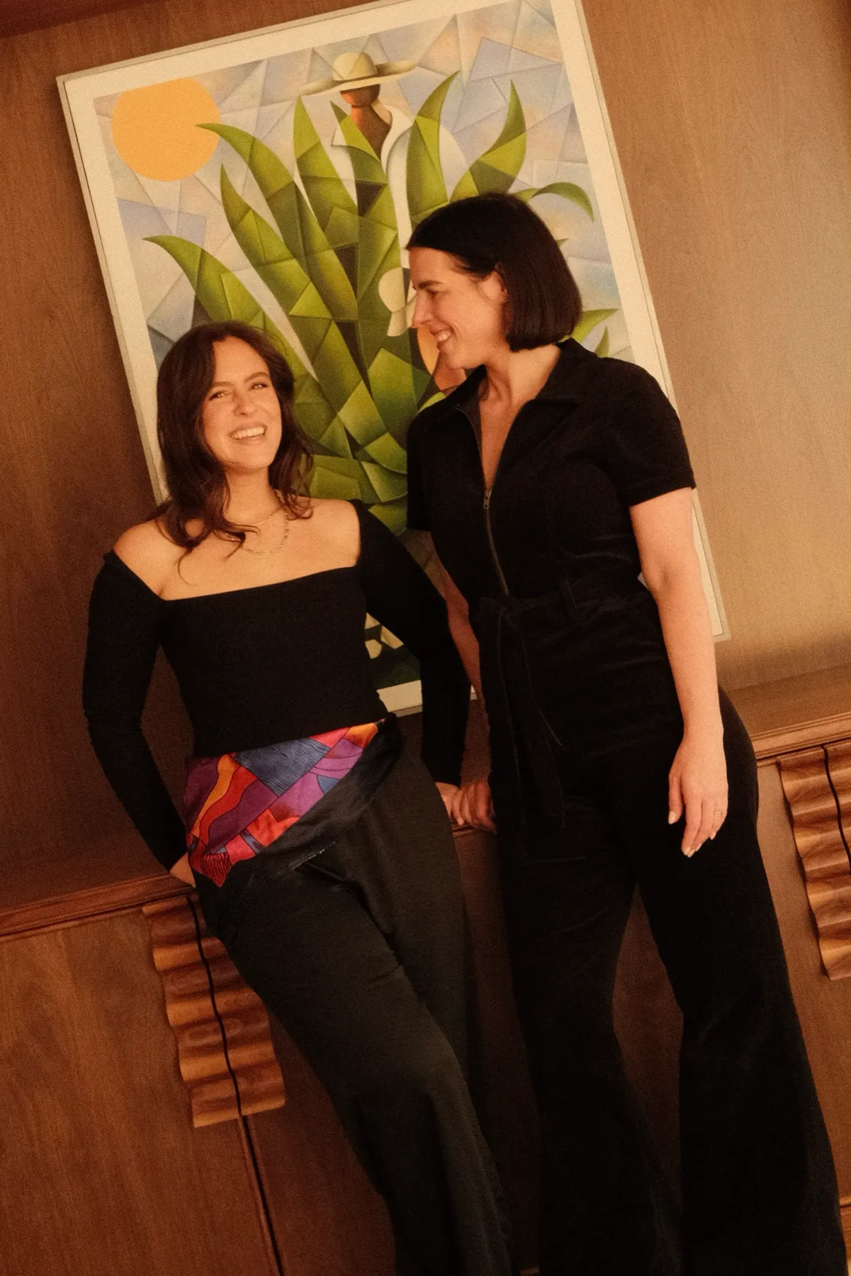 Lexi and Delana standing together in front of a painting