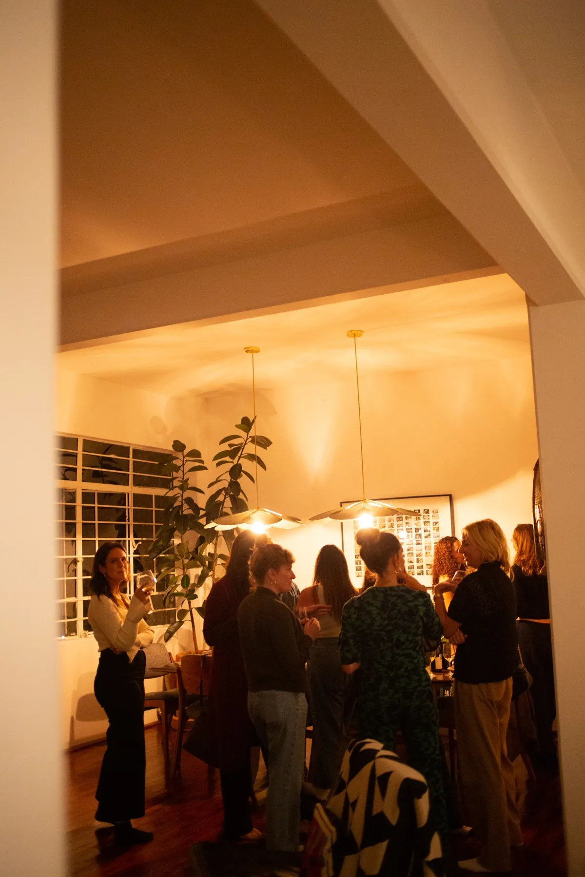 Women gathered in a warmly lit room at a Wealthkind event